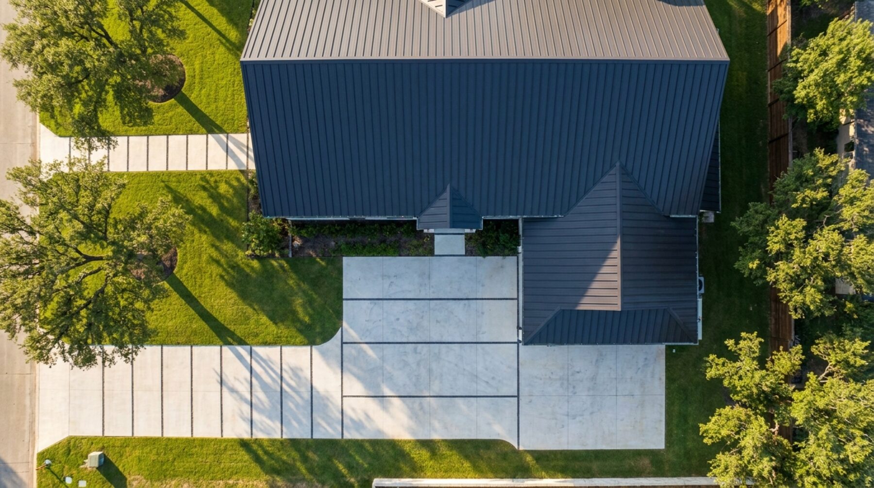 Aerial view of a suburban home and concrete driveway